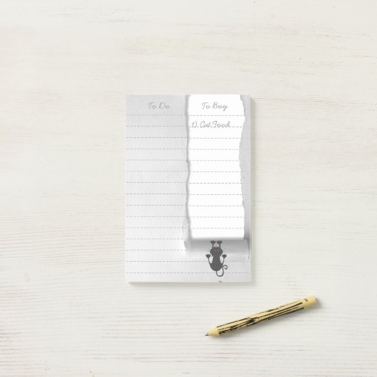 おもしろいで予測できない猫の引き裂く紙 ポストイット (デスク上)