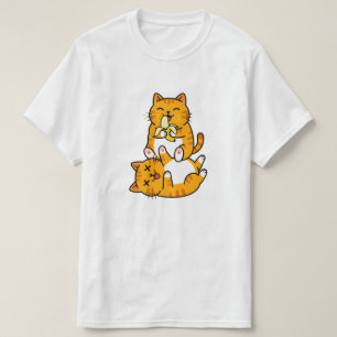 おもしろい猫がバナナを食べる ネコ かわいい漫画 オレンジ Tシャツ