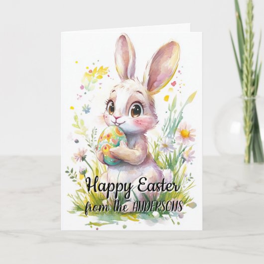 かわいいウサギがイースターエッグと花を持っている シーズンカード (正面)