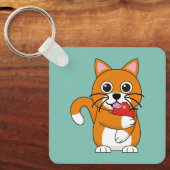 かわいいオレンジ色の白食べ猫の赤りんご漫画 キーホルダー (正面)