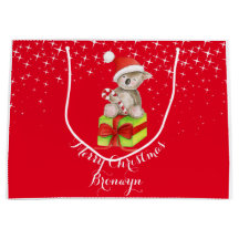 かわいいコアラの芸術はクリスマスの赤のギフトバッグを示しました