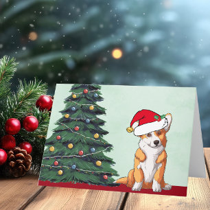 かわいいサンタ帽子をかぶったコーギーのクリスマスツリーの犬 シーズンカード