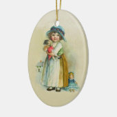 かわいい小さなヴィンテージの女の子のホールディングドールライトタン セラミックオーナメント (左)
