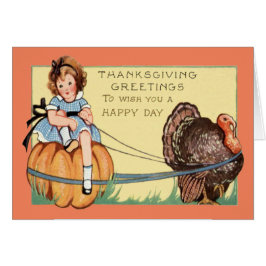 かわいい小さな女の子カボチャの七面鳥に乗る