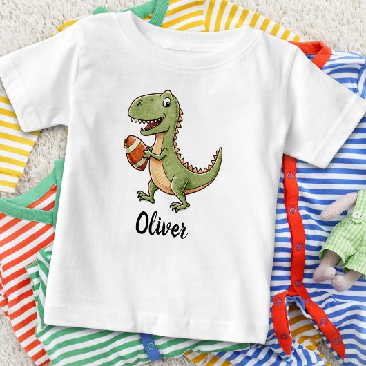 かわいい恐竜のフットボール ベビーTシャツ