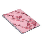 さくらんぼは白い背景にピンク色の花を咲かせる。 ノートブック (右側)