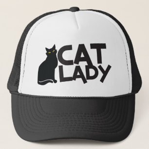 しなやかで優雅な黒猫の黄色の猫の女性は注目します キャップ