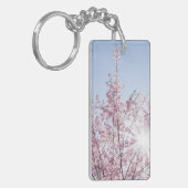 すさまじい木のピンク色の花を太陽が通過する キーホルダー (正面左)