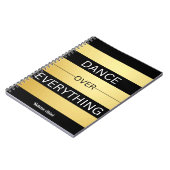 「すべてを越えて踊る」ブラック&金ゴールド ストライプの ノートブック (左側)