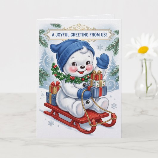 そりで楽しむ可愛い雪だるまのクリスマス カード (小さな植物)