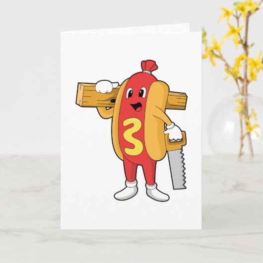 のこぎりと木材を持つ大工のホットドッグ カード (黄色い花)