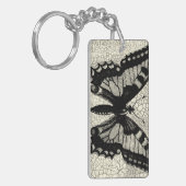 ひび割れた背景に黒と白の蝶 キーホルダー (正面左)