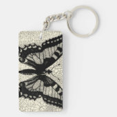 ひび割れた背景に黒と白の蝶 キーホルダー (裏面)