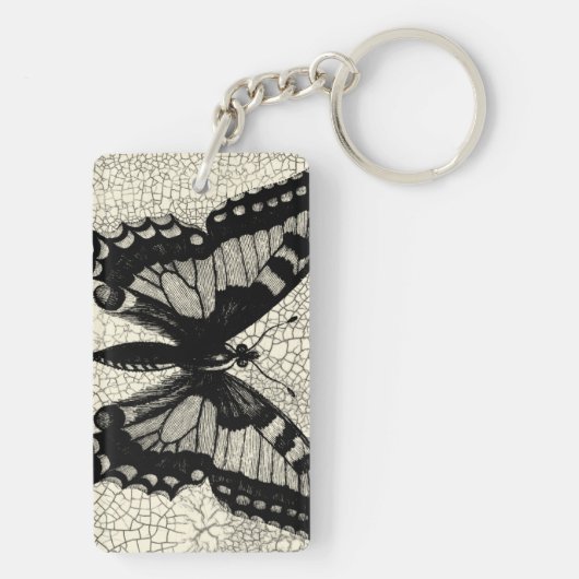 ひび割れた背景に黒と白の蝶 キーホルダー (裏面)
