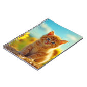 ひまわりの花畑で遊ぶ愛らしいオレンジ色の子猫 ノートブック (左側)