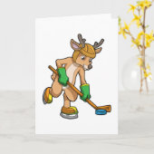 アイスホッケーでアイスホッケーのスティックを持つトナカイ カード (黄色い花)