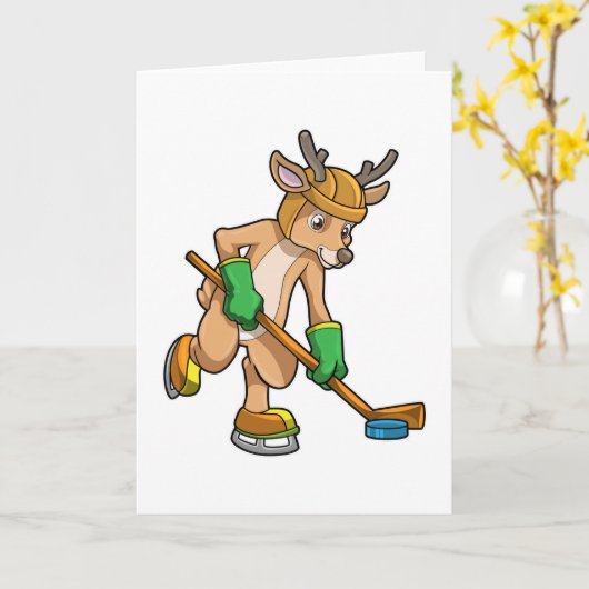 アイスホッケーでスティックを持つトナカイ カード (黄色い花)