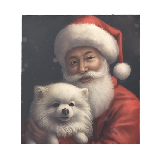アメリカン・エスキモー犬とサンタクロースのクリスマス ノートパッド (正面)