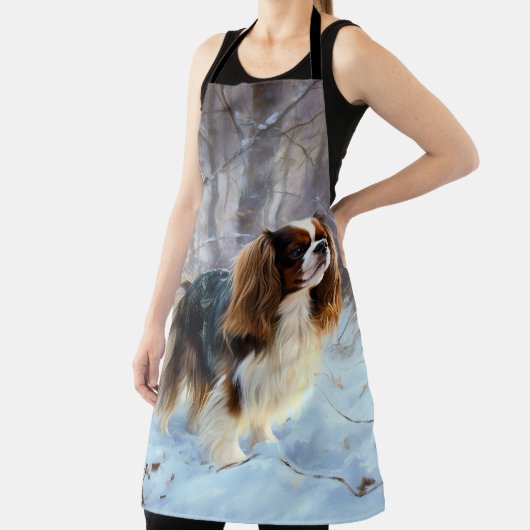 イギリスのおもちゃスパニエル犬が雪のクリスマスを過ごす エプロン (インサイチュ)