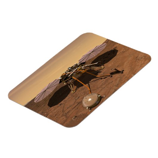 インサイト着陸装置が火星の表面で動作。 マグネット (左側)