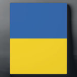 ウクライナ国旗のボタン フォトプラーク<br><div class="desc">ウクライナの国旗は、同じ大きさの2つの横縞の青と黄の旗で構成されている。上部は空を表し、黄色は小麦を表します。
 ウクライナ国旗</div>