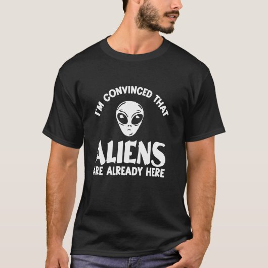 エイリアンは既にここに来ている – おもしろいエイリアン信者 Tシャツ (正面)
