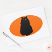 オレンジに黒いシルエットで座る 楕円形シール (封筒)