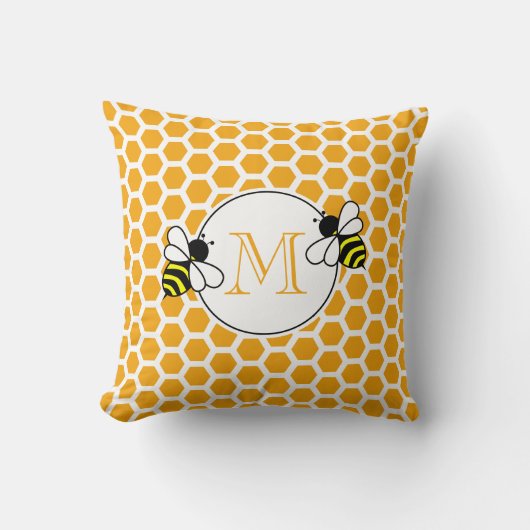 オレンジのハニカムと蜂のパターンが入ったモノグラム クッション (正面)