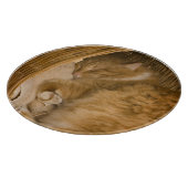 オレンジの虎猫がハンパーで眠っている カッティングボード (角)