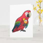 オレンジジュースの入ったガラスを持つパラロット カード (黄色い花)