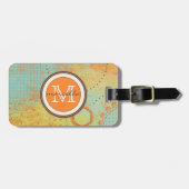 オレンジティール(緑がかった色)のペンキのコラージュのモノグラム ラゲッジタグ (正面横)