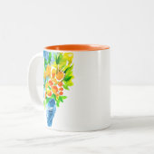 オレンジ色のクンクアットフルーツアートの水色 ツートーンマグカップ (正面左)