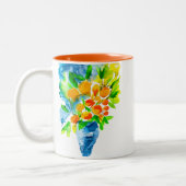 オレンジ色のクンクアットフルーツアートの水色 ツートーンマグカップ (左)