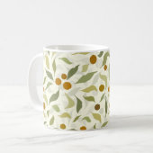 オレンジ色の果実葉とクリームのパターン。 コーヒーマグカップ (正面左)