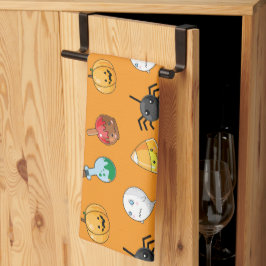 オレンジ色の背景を持つ可愛いハロウィンパターン キッチンタオル