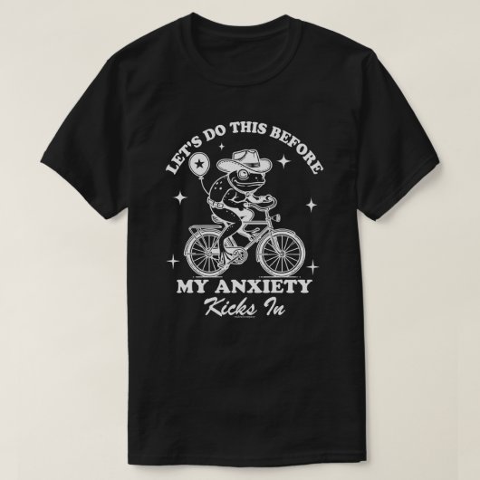 カウボーイのカエルが自転車に乗る おもしろTシャツ Tシャツ (デザイン正面)