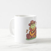 カウボーイハットとギターを持つかわいいカエル コーヒーマグカップ (正面左)