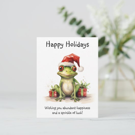 カエルとサンタハットギフト包まれたハッピーホリデー ポストカード (スタンド正面)