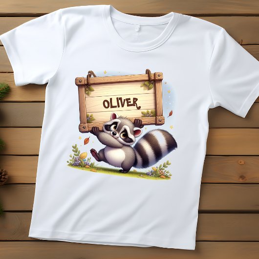 カスタマイズ可能な名前の看板を持つかわいいアライグマ ベビーTシャツ