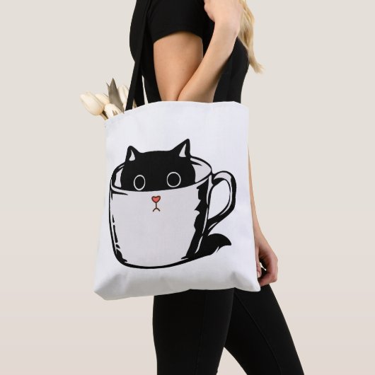 カップに赤い鼻を隠した黒い子猫 トートバッグ (クローズアップ)