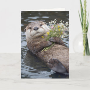 カワウソの誕生日お祝い 野生の花束といっしょに浮かぶ カード
