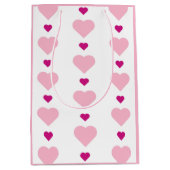 キュートな対称ピンクと白とハート ミディアムペーパーバッグ (正面)