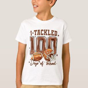 キュート!100日目の学校フットボールを乗り越えたよ キッズ Tシャツ