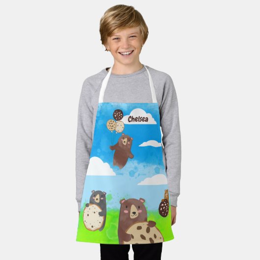 クッキー飛んでいるバルーンに子ども用の料理ベーキング エプロン (着用した状態)