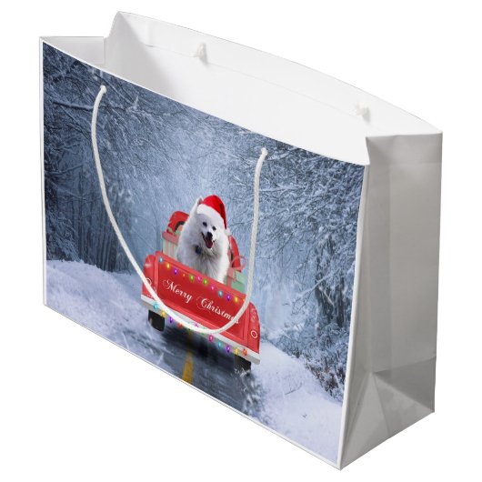 クリスマスに座る雪の中のアメリカのエスキモー犬 ラージペーパーバッグ (裏面アングル)