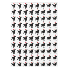 クリスマスのサンタクロースの帽子を身に着けている黒い実験室犬 テーブルクロス