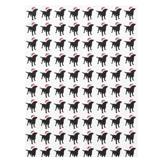 クリスマスのサンタクロースの帽子を身に着けている黒い実験室犬 テーブルクロス (正面)