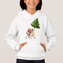 クリスマスのツリーバルーンを持つ遊び心のある子犬