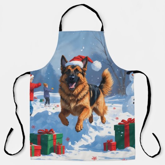 クリスマスの帽子をかぶって雪の中を走るジャーマンシェパード エプロン (正面)