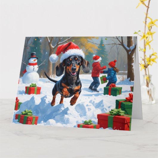 クリスマスの帽子をかぶって雪の中を走るダックスフント カード (黄色い花)